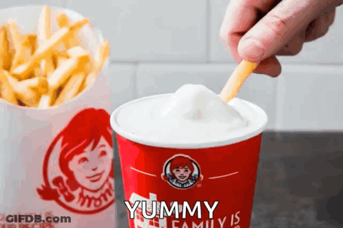 A Person Dipping French Fries Into A Wendy 'S Drink GIF