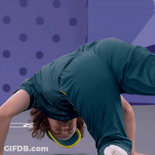 A Person Doing A Handstand In Front Of A Purple Background GIF
