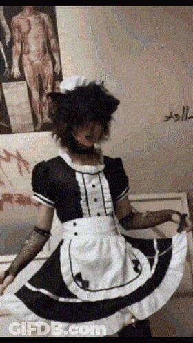 A Person Dressed As A Maid With A Cat Ear Wig GIF