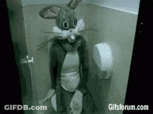 A Person Dressed As Bugs Bunny Is Sitting In A Toilet . GIF