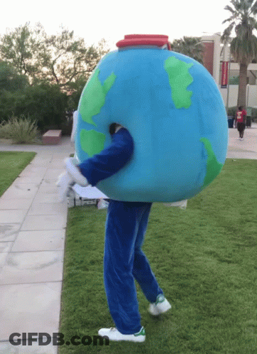 A Person Dressed In A Globe Costume Walking On A Grassy Sidewalk GIF