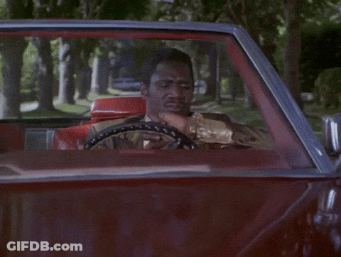 A Person Driving Down A Street With A Red Stop Sign GIF