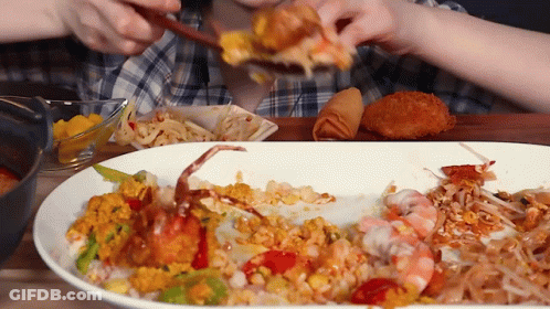 A Person Eating A Plate Of Food With A Crab On It GIF
