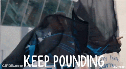 A Person Holding A Black Cloth That Says " Keep Pounding " GIF