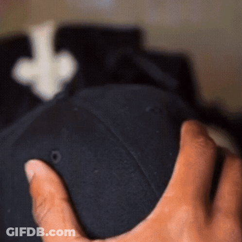 A Person Holding A Black Hat With An Arrow Pointing Up GIF