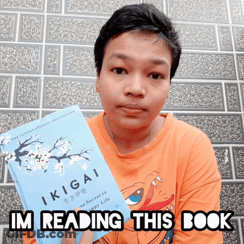 A Person Holding A Book Titled Ikigai And Says I 'M Reading This Book GIF
