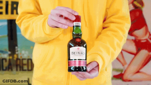 A Person Holding A Bottle Of Beirao In Their Hands GIF