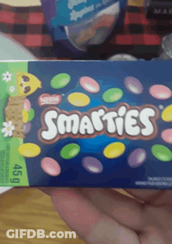 A Person Holding A Box Of Smarties Candy GIF