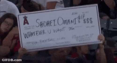 A Person Holding A Check That Says A Shohei Omani Whatever U Want GIF