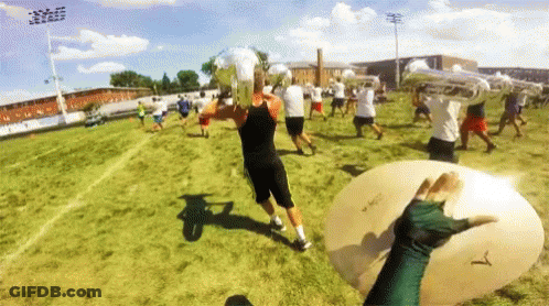 A Person Holding A Cymbal That Says T On It GIF