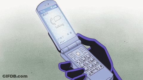 A Person Holding A Flip Phone That Says Talking On It GIF