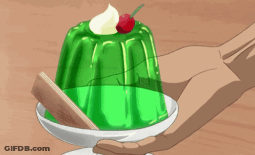 A Person Holding A Green Dessert With A Cherry On Top GIF