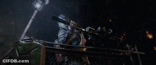 A Person Holding A Gun In A Dark Cave GIF
