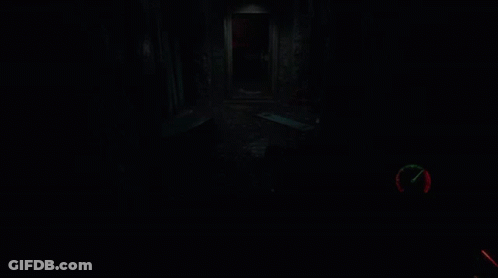 A Person Holding A Gun In A Dark Room With A Clock On It GIF