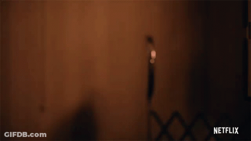 Person Holding Gun With Netflix Logo Background GIF