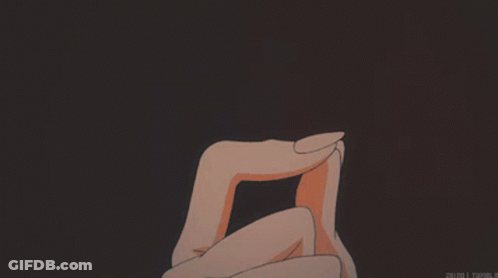 A Person Holding A Heart In Their Hands With A Dark Background GIF