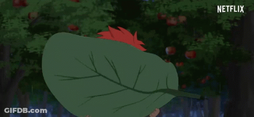 A Person Holding A Large Green Leaf In Front Of Their Face With Netflix Written In The Corner GIF