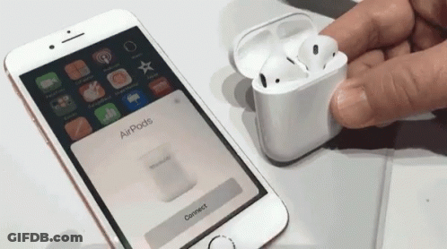 A Person Holding A Pair Of Airpods Next To A Phone That Says Connect GIF