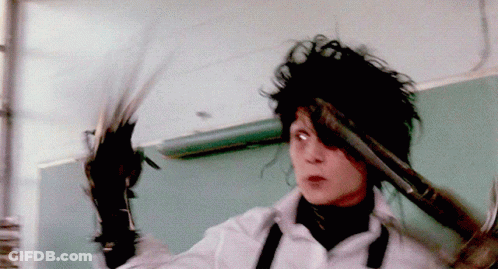 A Person Holding A Pair Of Scissors And A Hammer GIF