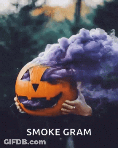 A Person Holding A Pumpkin With Smoke Coming Out Of It And The Words Smoke Gram Below It GIF