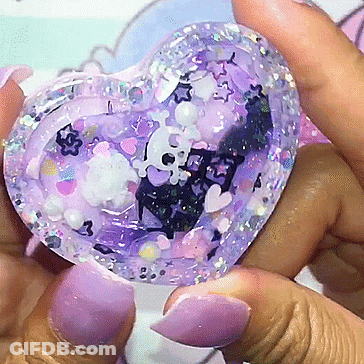 A Person Holding A Purple Heart Shaped Object GIF