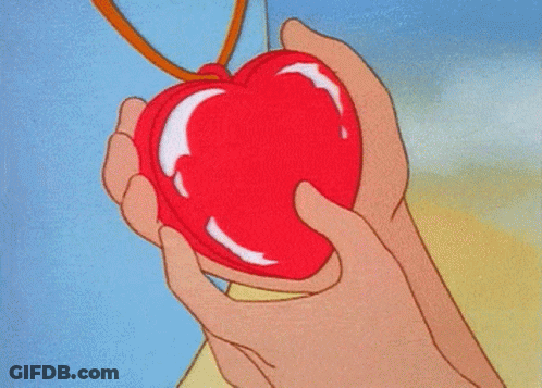 A Person Holding A Red Heart Shaped Object GIF