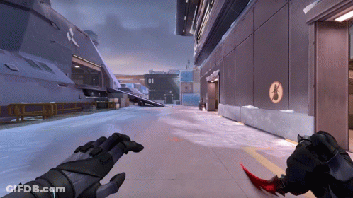 A Person Holding A Red Knife In Front Of A Building With The Number 01 GIF