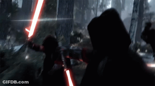 A Person Holding A Red Light Saber In The Dark GIF