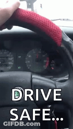 A Person Holding A Red Steering Wheel With The Words Drive Safe Written On It GIF