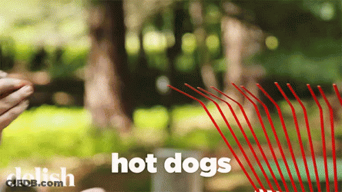 A Person Holding A Red Straw With The Words Hot Dogs Written On It GIF