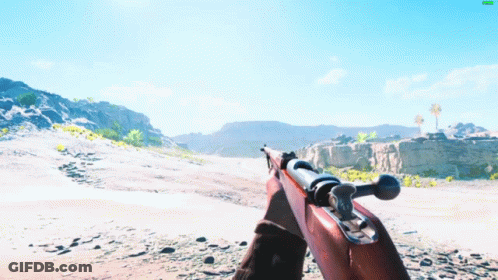 A Person Holding A Rifle In A Desert Landscape GIF