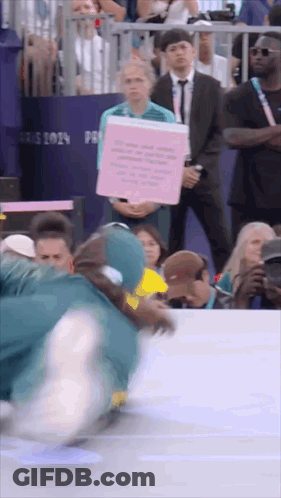 A Person Holding A Sign That Says " Paris 2019 " GIF