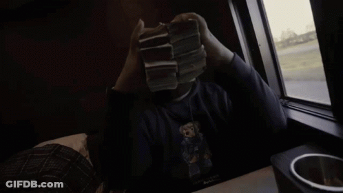 A Person Holding A Stack Of 20 Dollar Bills In Front Of A Window GIF