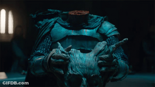 A Person Holding A Statue With A Headless Torso GIF