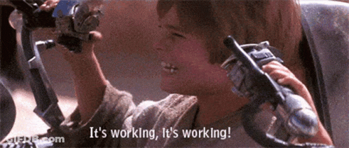 A Person Holding A Steering Wheel With The Words " It 'S Working It 'S Working " Above Them GIF