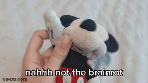 A Person Holding A Stuffed Mickey Mouse With The Words " Nahhh Not The Brainrot " Above It GIF