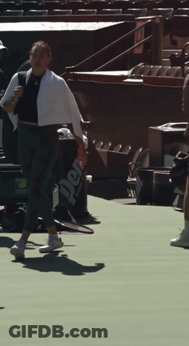 A Person Holding A Tennis Racquet On A Court With A Bag That Says Perf On It GIF