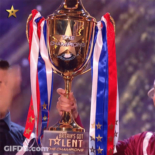 A Person Holding A Trophy That Says Britain 'S Got Talent GIF