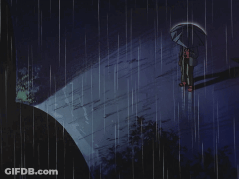 A Person Holding An Umbrella Stands In The Rain GIF