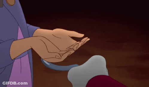 A Person Holding Another Person 'S Hand In A Dark Room GIF