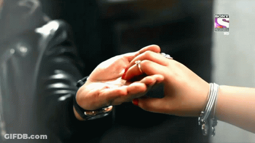 A Person Holding Another Person 'S Hand In Front Of A Sony Television Logo GIF