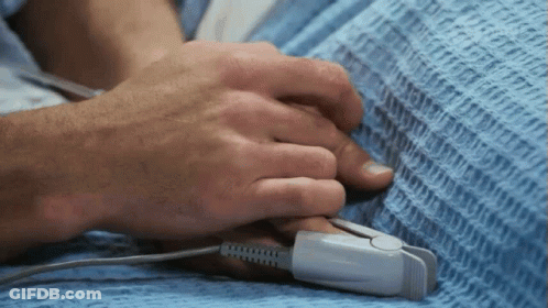 A Person Holding Another Person 'S Hand With A Pulse Oximeter Attached To It GIF