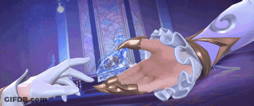 A Person Holding Another Person 'S Hand With The Letter G On It GIF