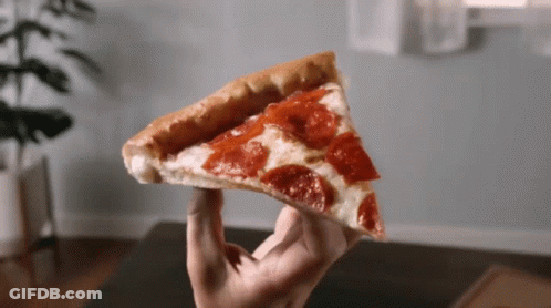 A Person Holds A Slice Of Pepperoni Pizza In Their Hand GIF