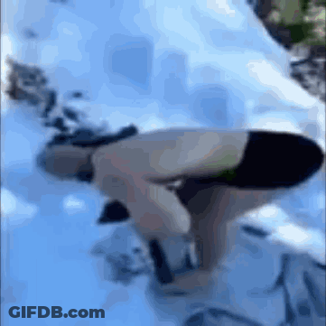 A Person In A Bikini Is Bending Over In The Snow GIF