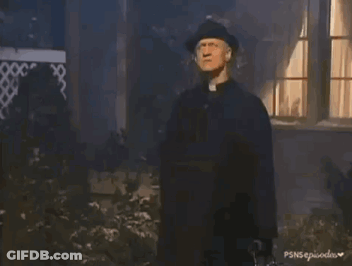 A Person In A Black Glove Is Holding A Small White Bottle With A Cross On It GIF