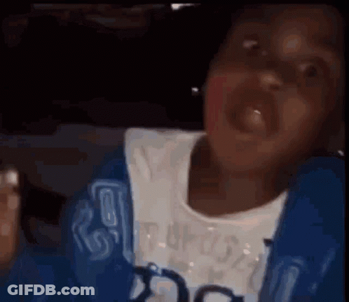 A Person In A Blue Jacket Is Making A Funny Face While Sitting In A Car . GIF