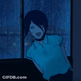 A Person In A Blue Shirt Is Standing In Front Of A Window At Night GIF