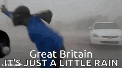 A Person In A Blue Shirt Is Standing In The Rain With The Words Great Britain It 'S Just A Little Rain On The Bottom GIF