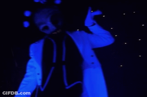 A Person In A Blue Suit With A Skull Mask On Their Face GIF